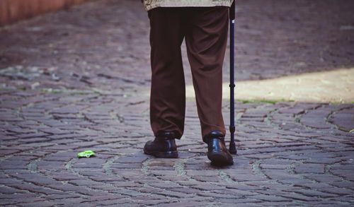 Low section of man waking on footpath