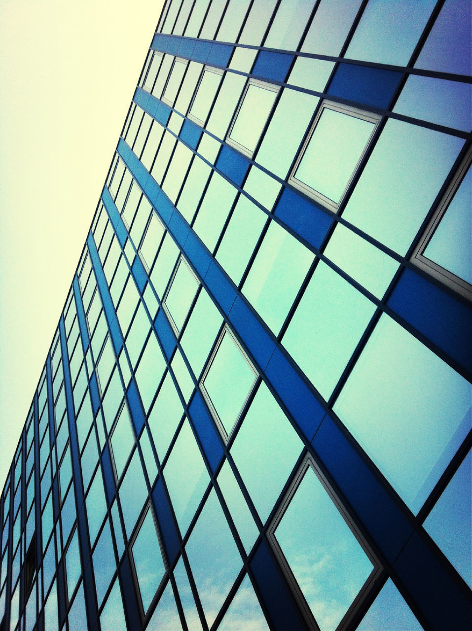 architecture, low angle view, built structure, modern, glass - material, building exterior, office building, pattern, reflection, window, building, city, clear sky, glass, full frame, skyscraper, tall - high, backgrounds, geometric shape, sky