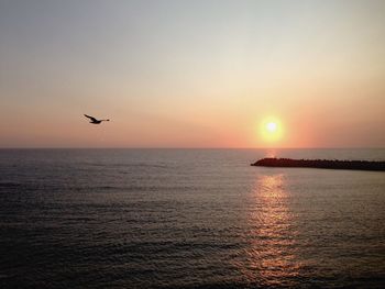 Scenic view of sea against clear sky during sunset