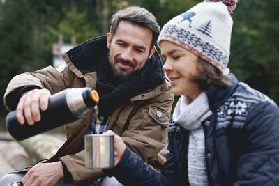 Man and woman holding drink