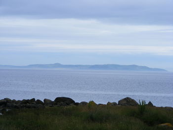 Scenic view of sea against cloudy sky