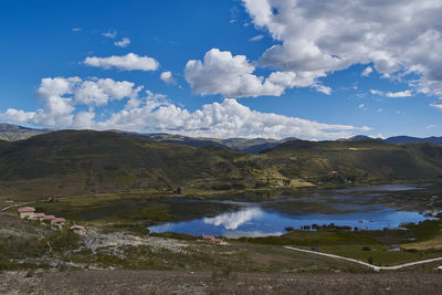 Scenic view of lake and mountains against sky