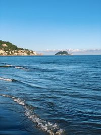 Scenic view of sea against clear blue sky