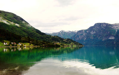 Scenic view of lake and mountains against sky