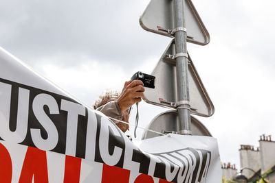 Man using camera during protest in city