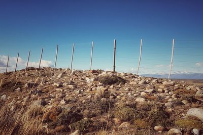 Low angle view of land against clear blue sky