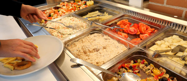 Inside a self service restaurant with raw and cooked foods