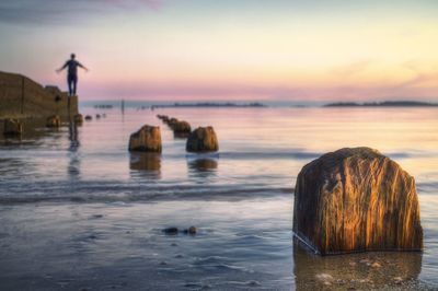 Scenic view of sea against sky at sunset