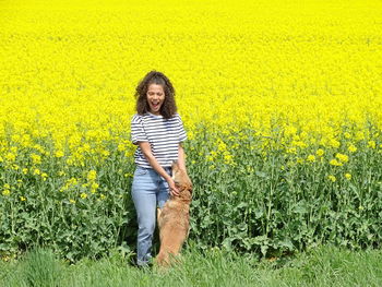 Portrait of smiling woman standing on field