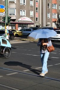 Full length of woman holding umbrella