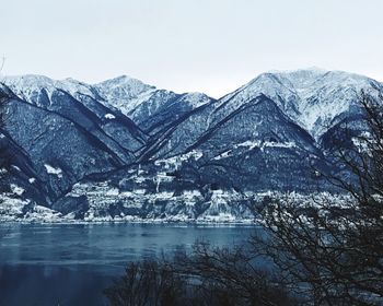 Scenic view of lake and snowcapped mountains against sky