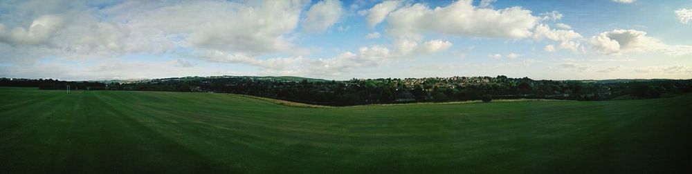 Scenic view of field against cloudy sky