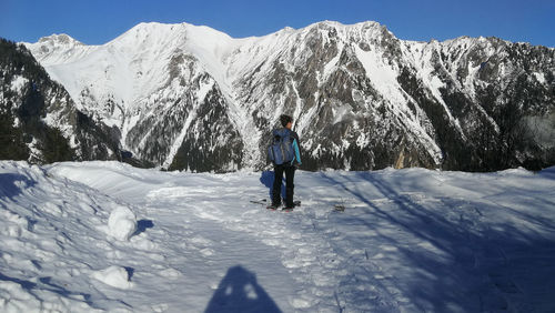 High angle view of woman standing on snowcapped landscape