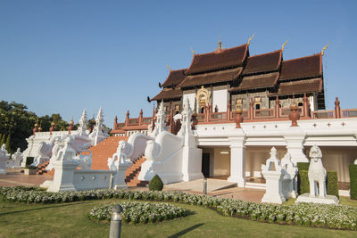 Statues on building against clear sky