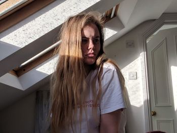 Young woman with long hair at home