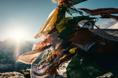 Close-up of prayer flags on mountain during sunny day