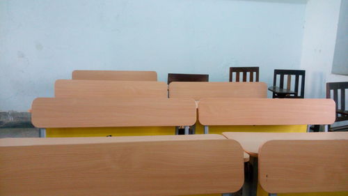Empty benches and table arranging in classroom