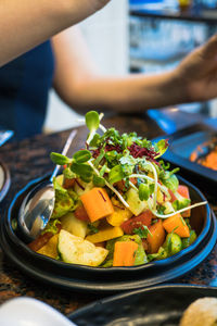 Close-up of person holding food in plate