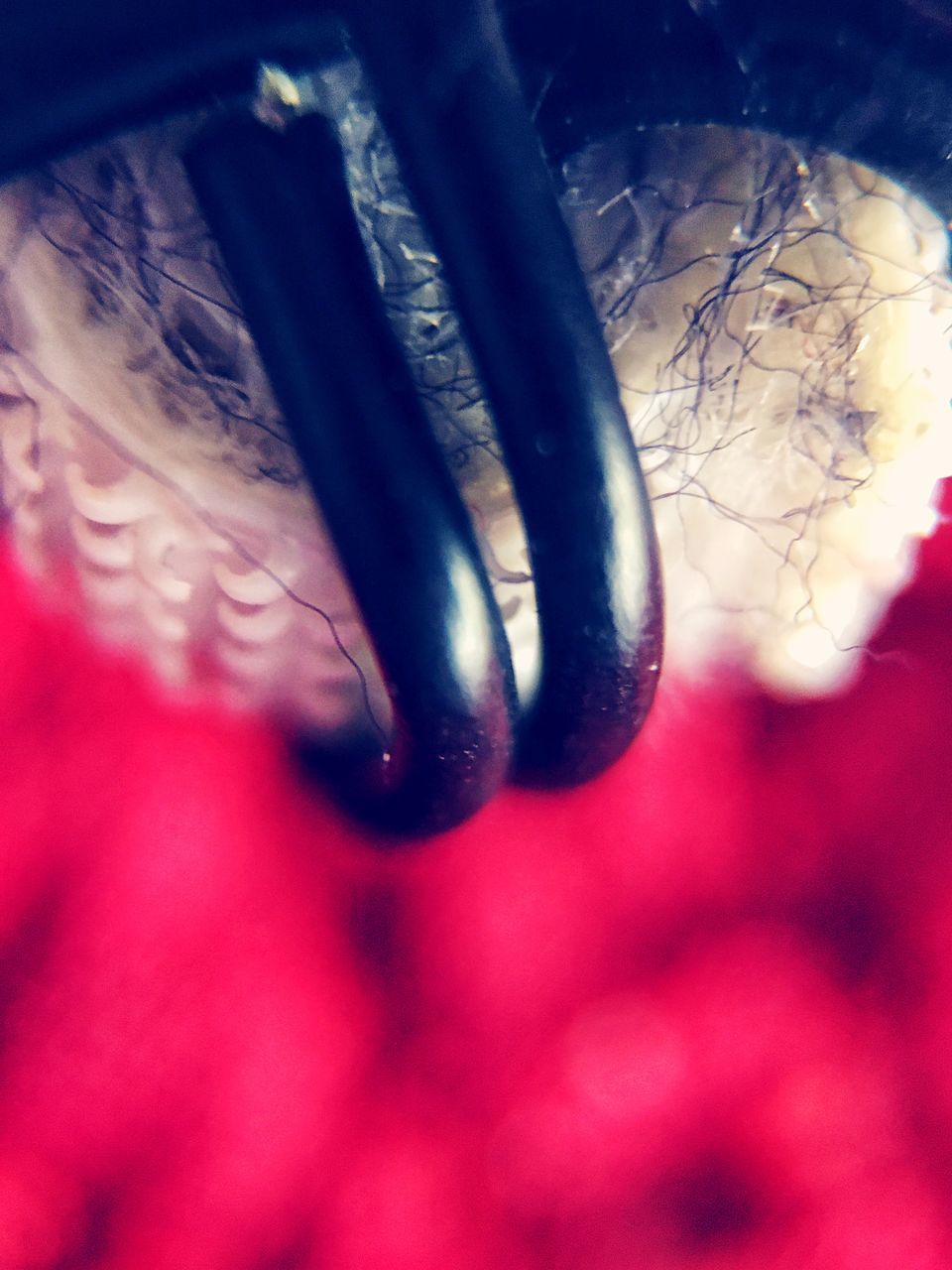 CLOSE-UP OF HUMAN HAND AGAINST METAL