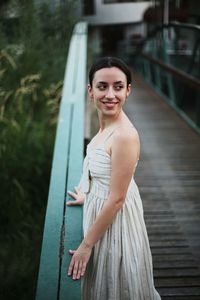 Portrait of a beautiful young woman on a pier