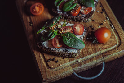 Sandwich with cream cheese, cherry tomatoes, spinach and spices. delicious healthy veggie food. 