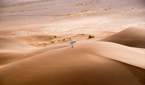 Full length of person on sand dune in desert