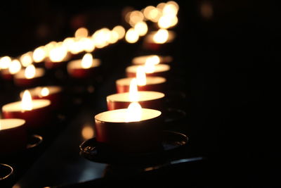 Close-up of illuminated tea light candles