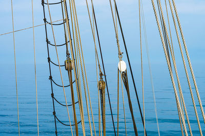 Low angle view of sailboat against blue sky