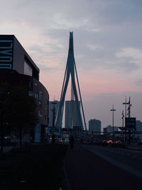View of bridge and buildings against sky during sunset