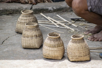 Low section of male vendor selling wicker container at market