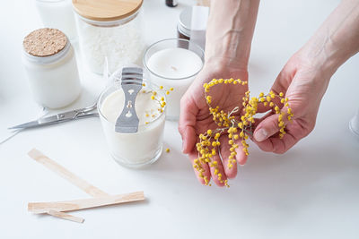 Cropped hands of woman holding food on table