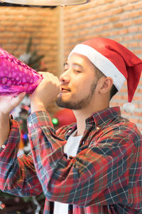 Close-up of young man enjoying during christmas party