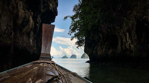 Rock formations by sea against sky