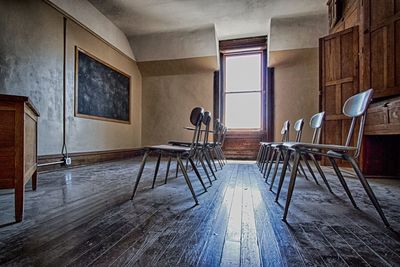 Empty chairs and table against wall at home