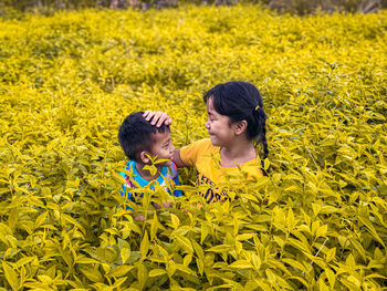 Rear view of two people on field