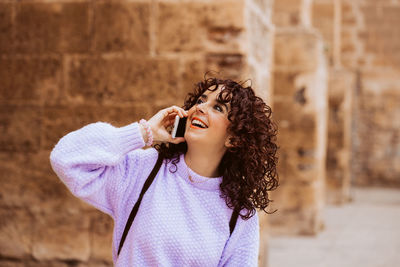 Portrait of young woman wearing sunglasses standing outdoors