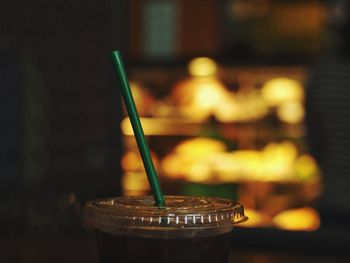 Close-up of starbucks glass on table