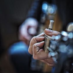 Cropped image of hand playing guitar