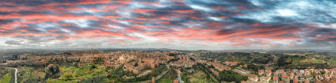 Panoramic view of city against sky during sunset