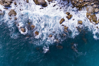 High angle view of rocks in sea