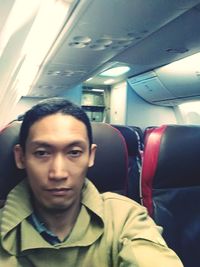 Portrait of man sitting in airplane