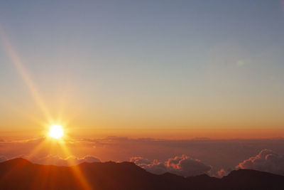 Scenic view of silhouette mountains against sky during sunset