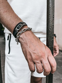 Midsection of man wearing bracelet