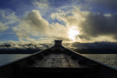 Pier over sea against sky during sunset