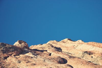 Low angle view of rock formations against sky