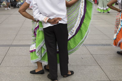 Low section of woman in traditional clothing walking on street in city