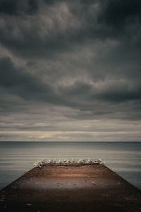 Scenic view of sea against cloudy sky