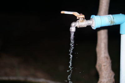 Close-up of water splashing against black background