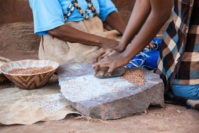 Midsection of woman grinding seeds