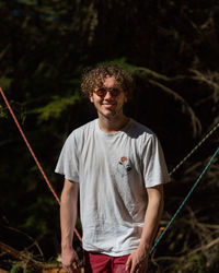 Portrait of smiling young man standing on land
